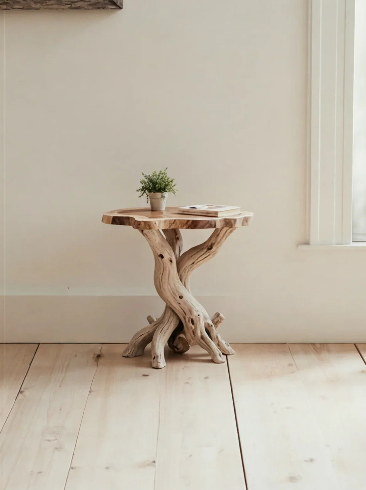 Live edge solid wood side table with sculptural twisted base, potted plant, and book.