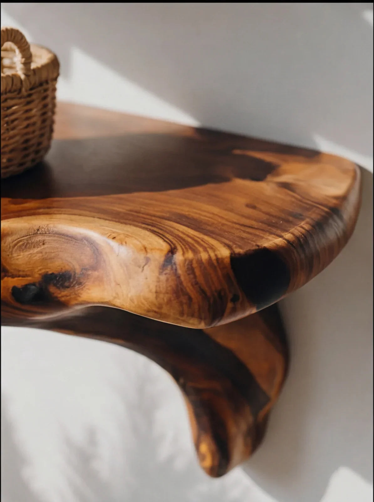 Live edge solid wood floating shelf with natural grain against white wall