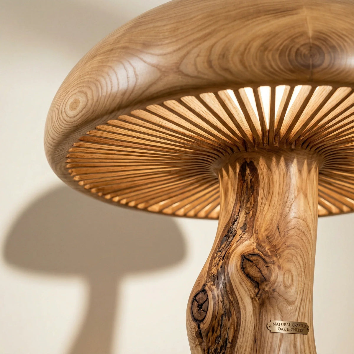 Close-up of wooden mushroom floor lamp with sculpted branch stem and glowing cap