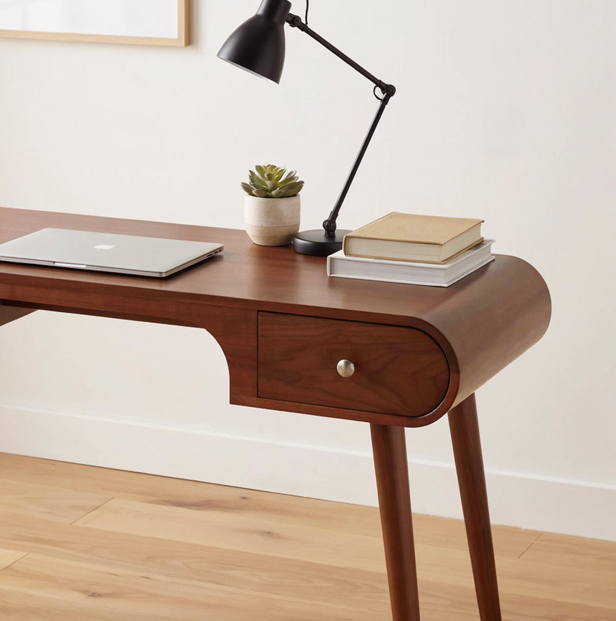 Solid wood writing desk featuring organic curved lines and built-in drawers