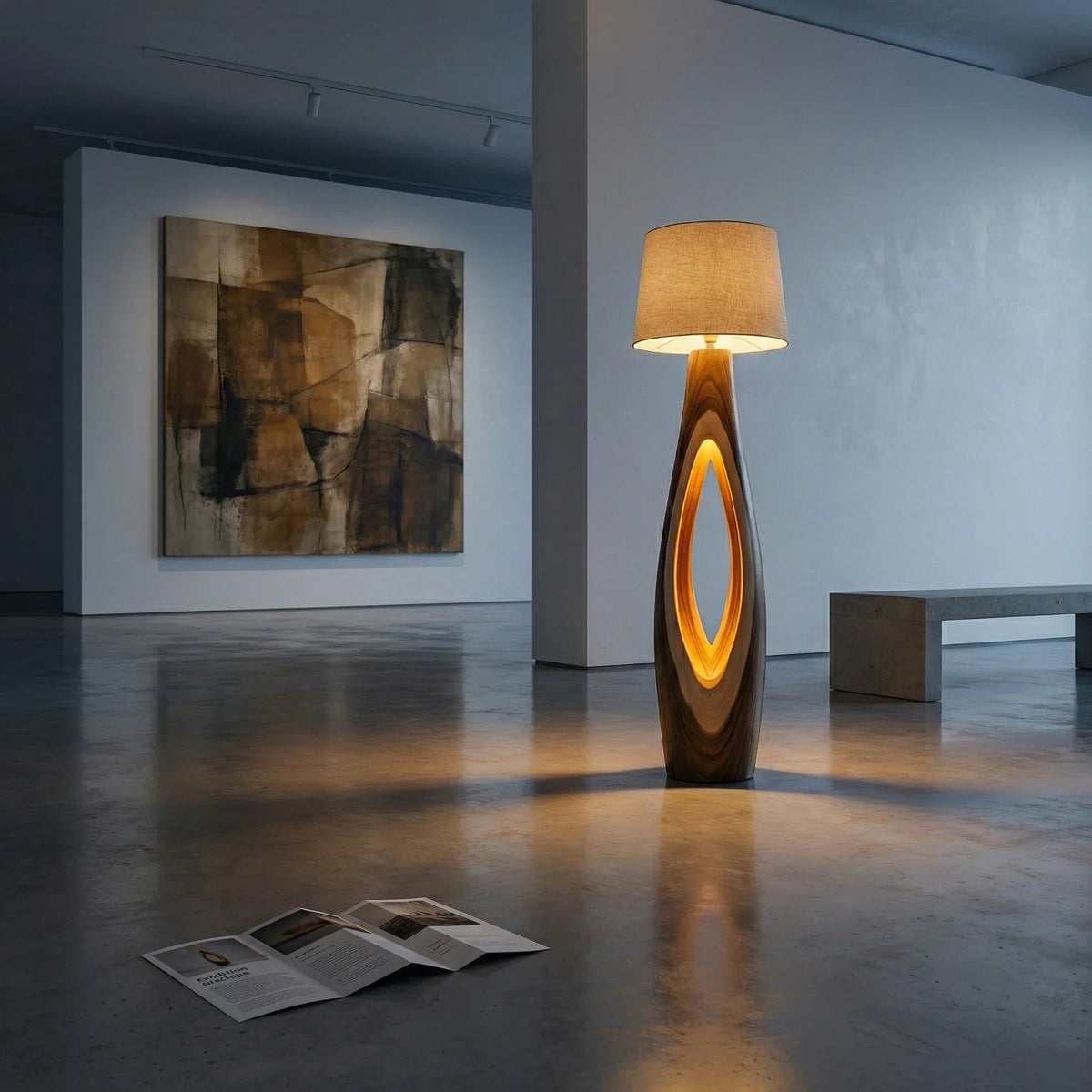 Modern art gallery loft with illuminated sculptural wood floor lamp, abstract painting, and concrete bench