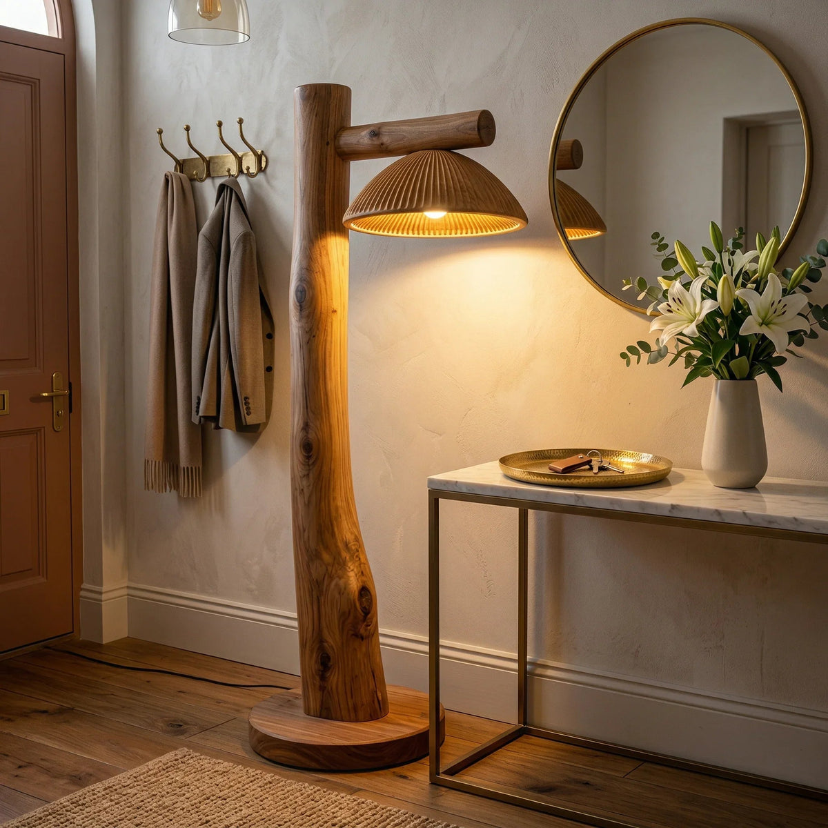 Modern entryway with a sculpted wood mushroom floor lamp, metallic accents, and floral decor