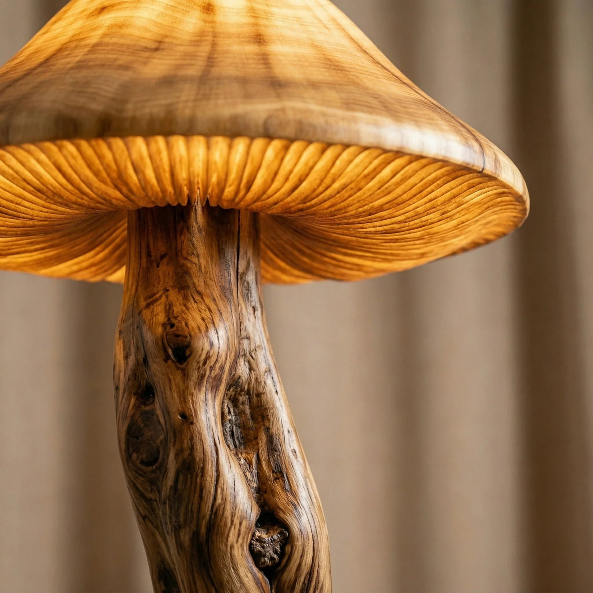 Mushroom floor lamp with sculpted wood stem and glowing translucent cap, close-up view