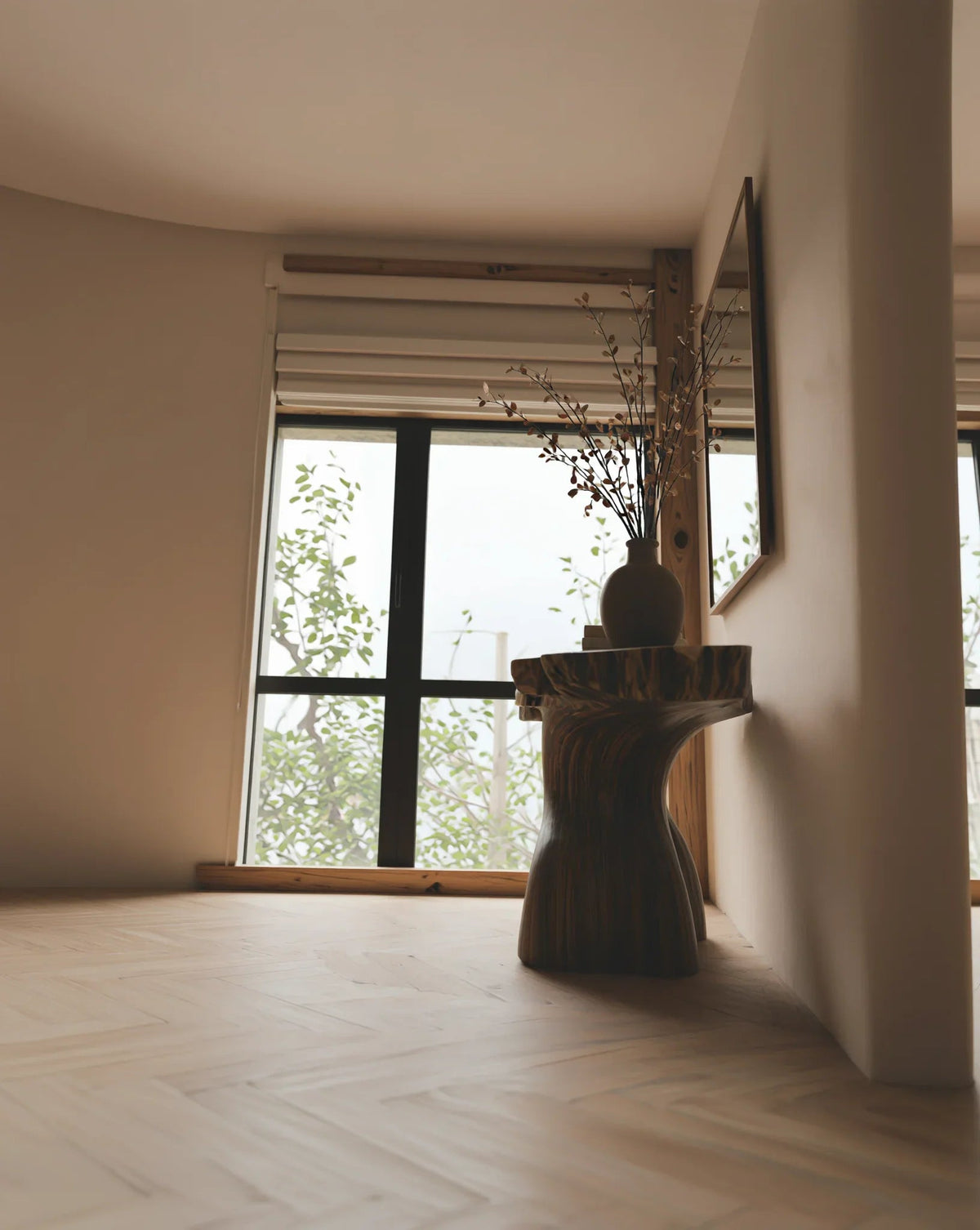 Solid wood live edge side table with vase in modern minimalist room by large window